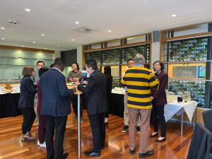 Photo from the ECR event. People are standing in groups of conversation.
