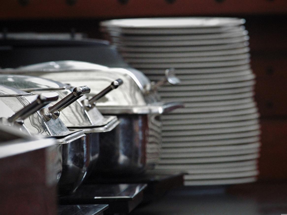 A stack of plates at a buffet table