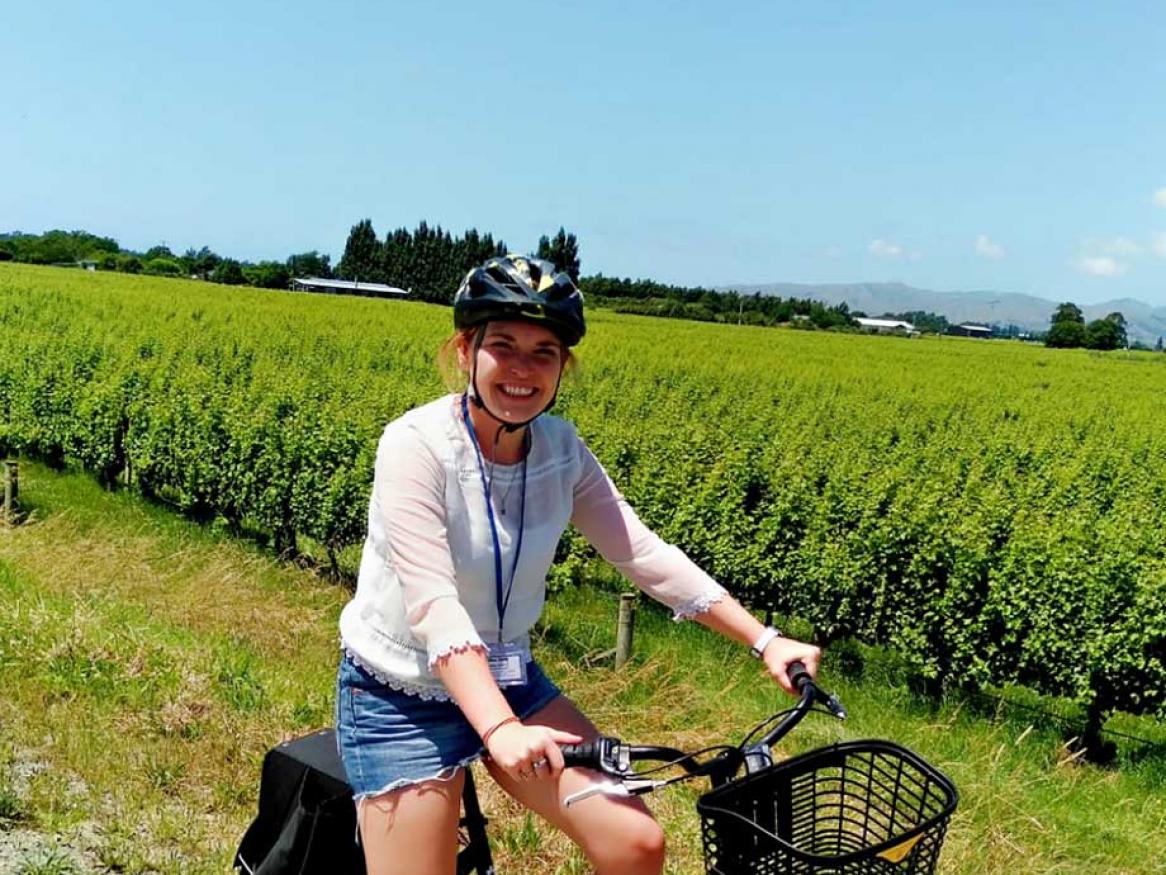 Hannah on a bike amongst vineyards
